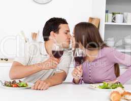 Cute couple giving a toast while having lunch