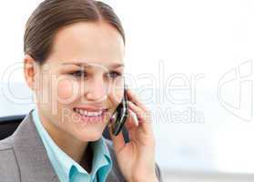 Female executive using her cellphone at her desk