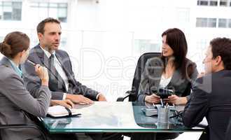 Charismatic businessman talking to his partners during a meeting