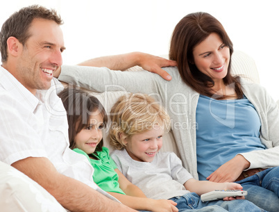 Parents and children watching television together