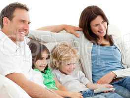 Parents and children watching television together