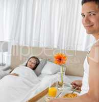 Portrait of a man bringing the breakfast to his girlfriend