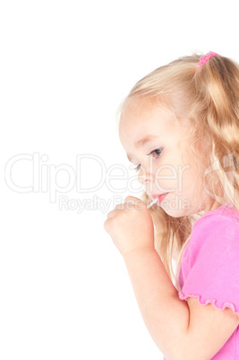 Little cute girl in studio eating candy