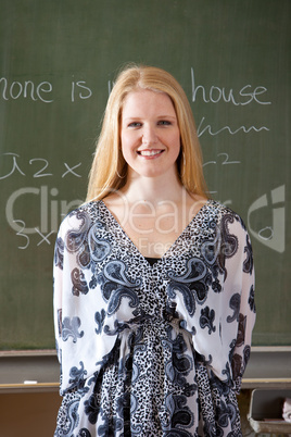 In front of the blackboard