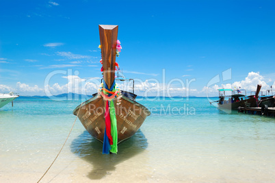 Traditional Thai style boat on turquoise water at the beach of P