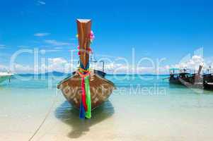 Traditional Thai style boat on turquoise water at the beach of P