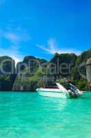 Motor boat on turquoise water of Maya Bay lagoon, Phi Phi island