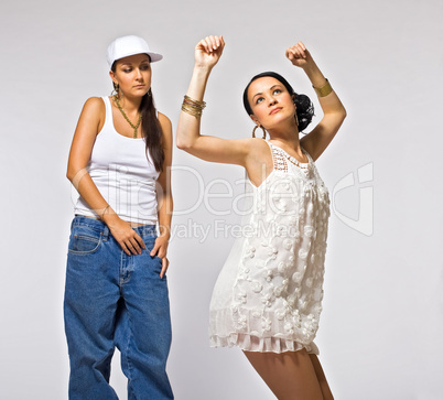 Two young woman dance