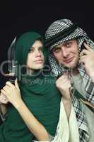 Arabian pair with sharp knifes and a mobile phone