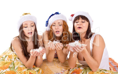 three woman blow feather