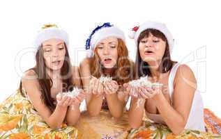 three woman blow feather