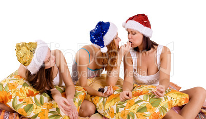 three young woman play on pillows