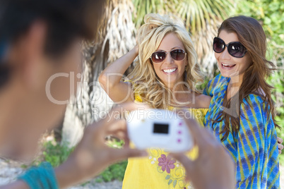 Three Young Women Friends Taking Pictures On Vacation