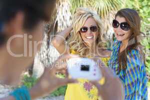 Three Young Women Friends Taking Pictures On Vacation