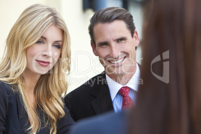 Attractive Businesswoman in Meeting with Colleagues
