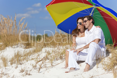 Man & Woman Couple Under Colorful Umbrella on Beach