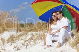 Man & Woman Couple Under Colorful Umbrella on Beach