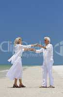 Happy Senior Couple Dancing Holding Hands on A Tropical Beach