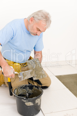 Home improvement, renovation - handyman laying tile