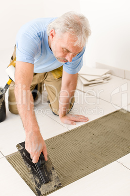 Home improvement, renovation - handyman laying tile