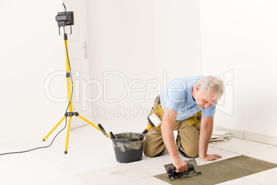 Home improvement, renovation - handyman laying tile