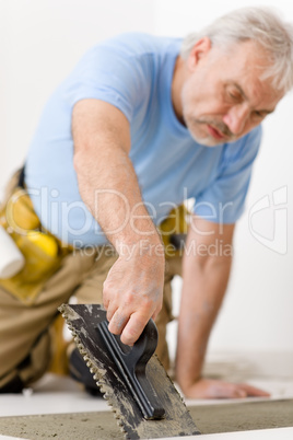 Home improvement, renovation - handyman laying tile