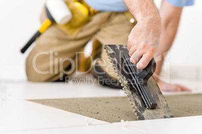 Home improvement, renovation - handyman laying tile