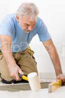 Home improvement, renovation - handyman laying tile