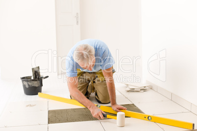 Home improvement, renovation - handyman laying ceramic tile