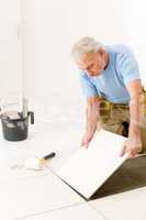 Home improvement - handyman laying ceramic tile