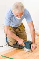 Home improvement - handyman sanding wooden floor