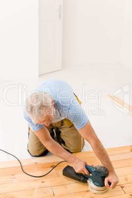 Home improvement - handyman sanding wooden floor