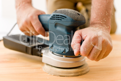 Home improvement - handyman sanding wooden floor