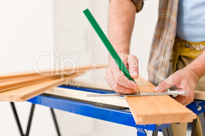 Home improvement - close-up of handyman measure wood