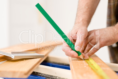 Home improvement - close-up of handyman measure wood