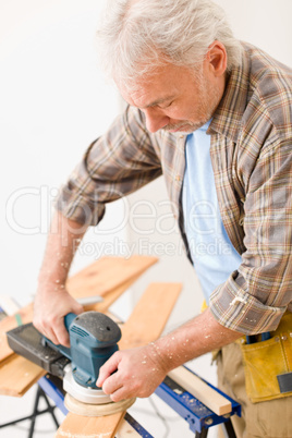 Home improvement - handyman sanding wooden floor