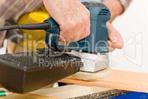 Home improvement - handyman sanding wooden floor
