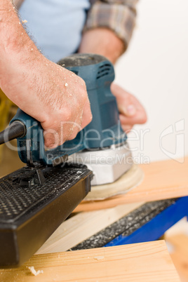 Home improvement - handyman sanding wooden floor