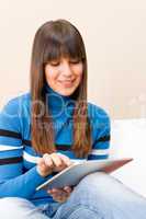 Teenager girl relax home with touch screen tablet computer