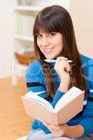 Teenager girl home - happy student with book