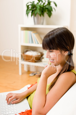 Teenager girl relax home - happy with laptop