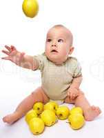 Little boy play with apples