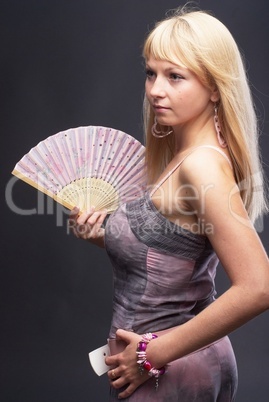 Beautiful young woman with fan