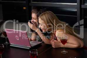 Group with laptop in cafe