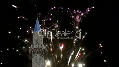 Fireworks explode over mosque turret 1