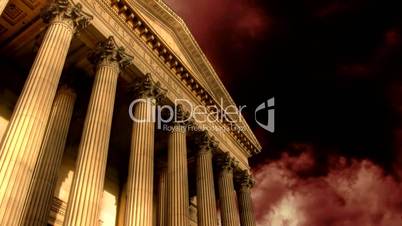 Classic columned building with timelapse storm clouds