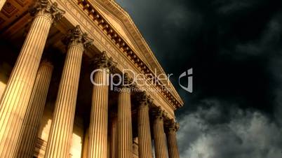 Columned historic building with timelapse storm clouds