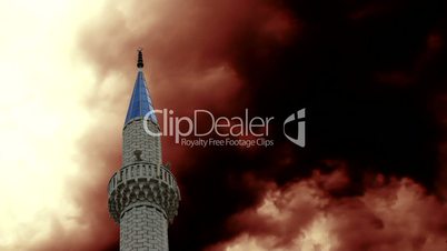 Timelapse storm clouds behind mosque minaret