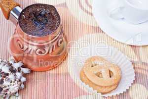 Turkish coffee in copper coffee pot and cookies