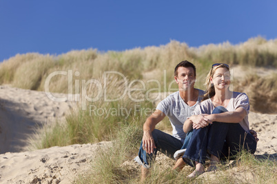 Romantic Man and Woman Couple Sitting Together On A Beach